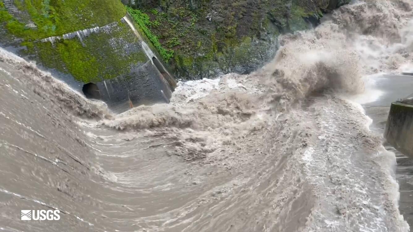 water crashing over a dam spillway