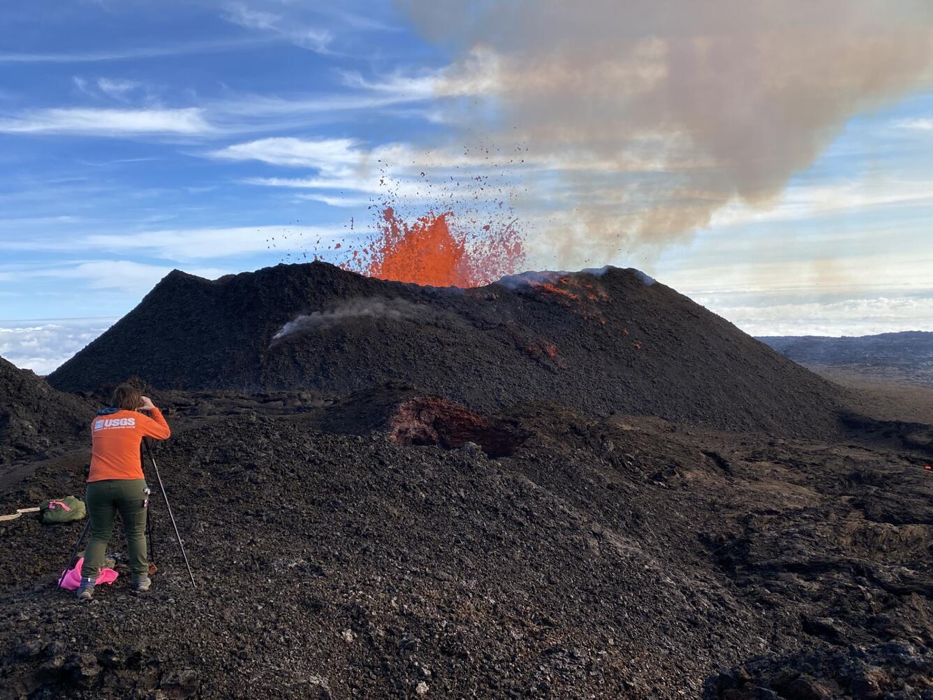 Color photograph of scientist measuring eruption
