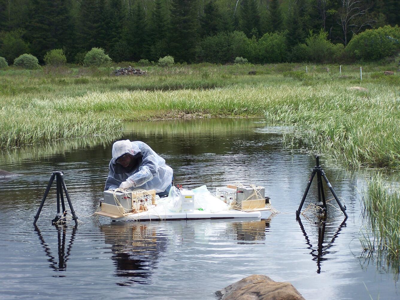 USGS National Research Program scientist taking water samples in a streambed.