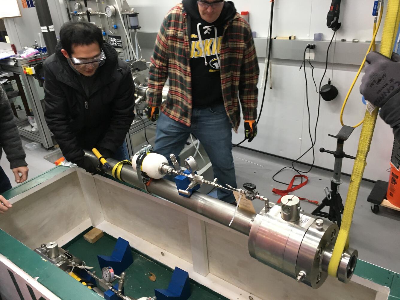  Junbong Jang and Stephen Phillips loading a pressure core chamber into a shipping box