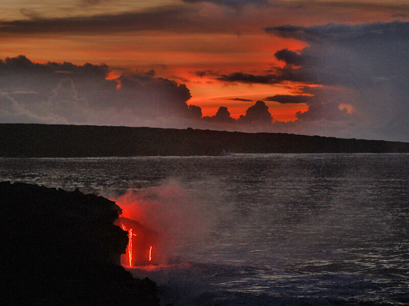This is a photo of lava falls continuing as sky starts to lighten and dawn approaches.