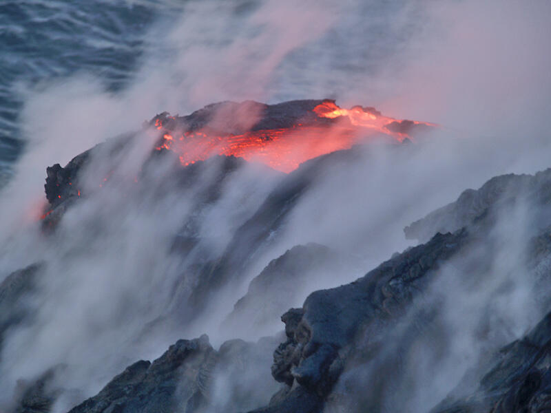 This is a photo of a pool of lava residing atop point feeding lava falls.