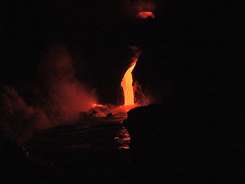 This is a photo of lava droping into the water from a lava tube at front of eastern Lae`apuki delta.