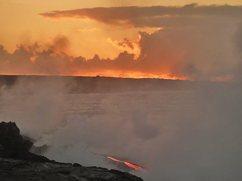 This is a photo of the rising sun set over a lava stream at front of Banana delta.