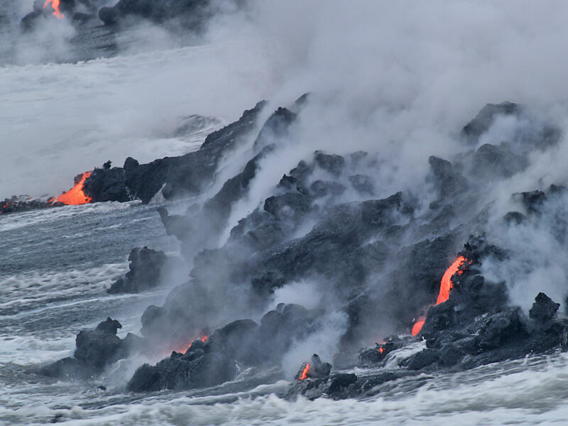 This is a photo of lava slowly constructing small mound outward from sea cliff.