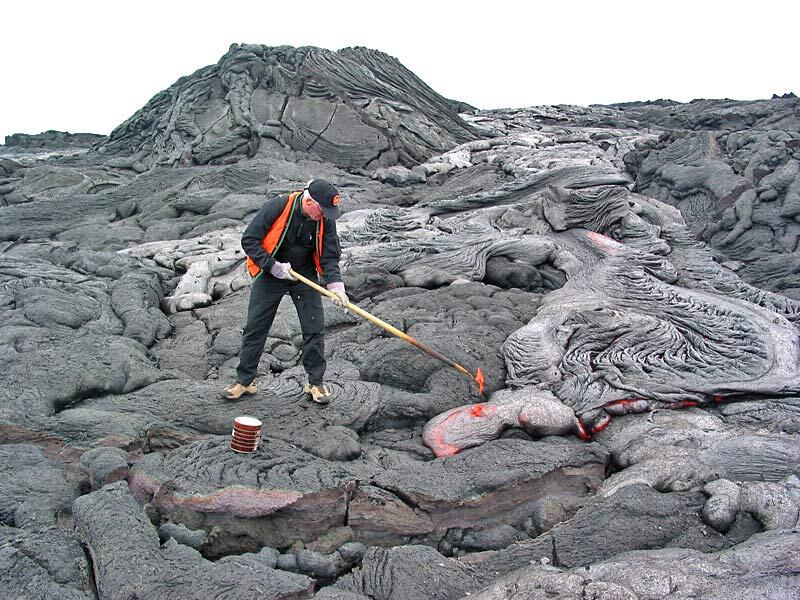 This is a photo of a researcher sampling lava with modified hoe from small flow just east of Banana flow.