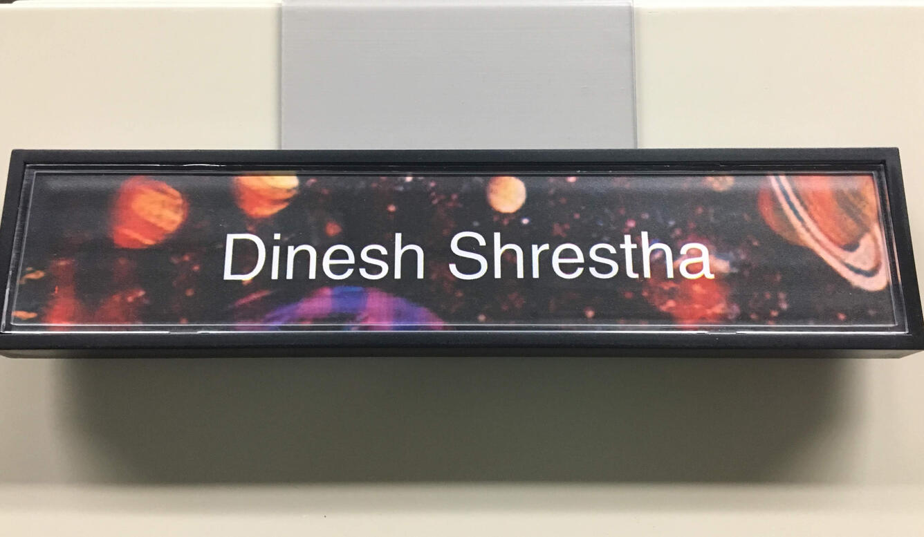 Color photo of Dinesh Shrestha nameplate
