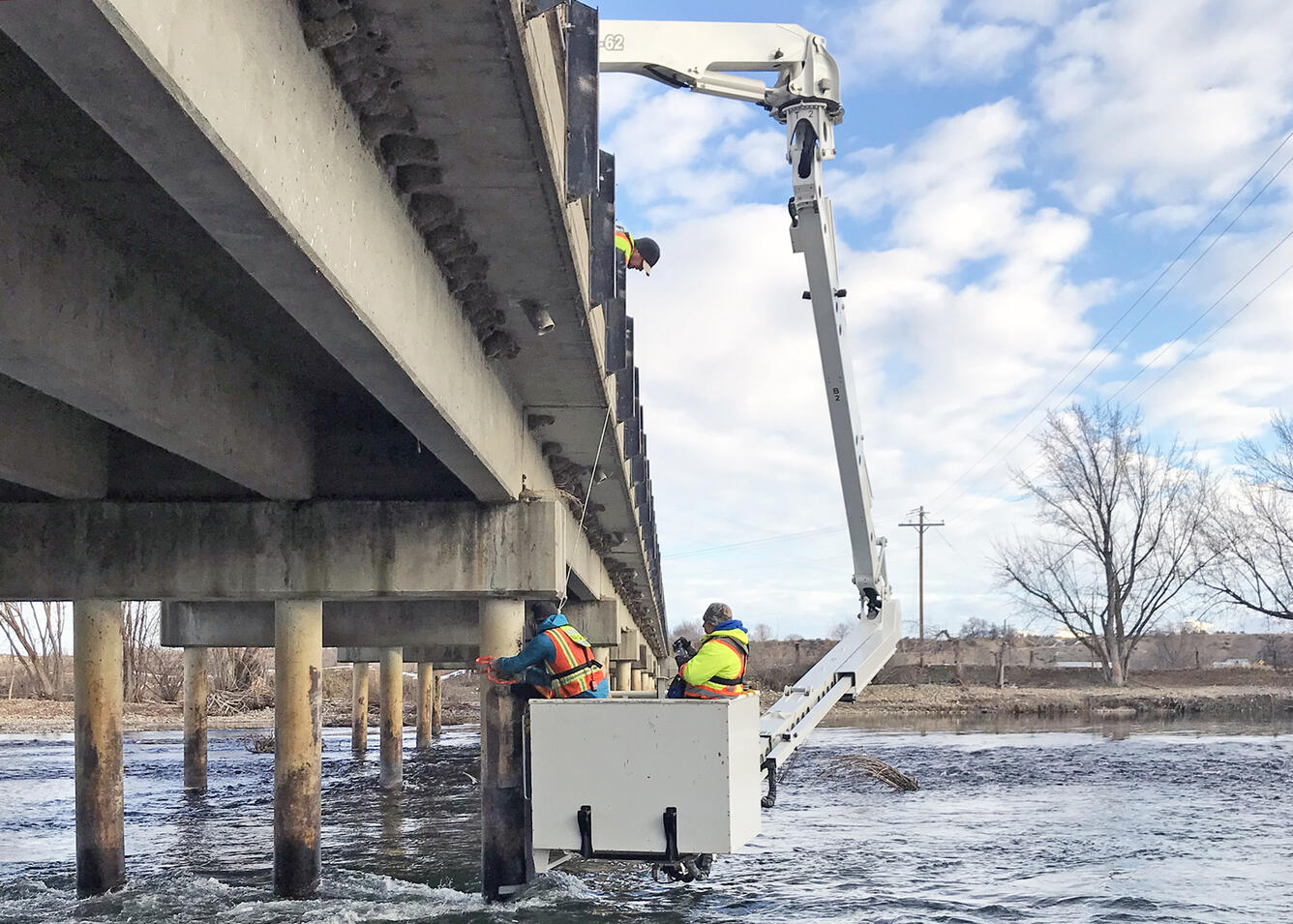 Technicians installing an echosounder on a bridge
