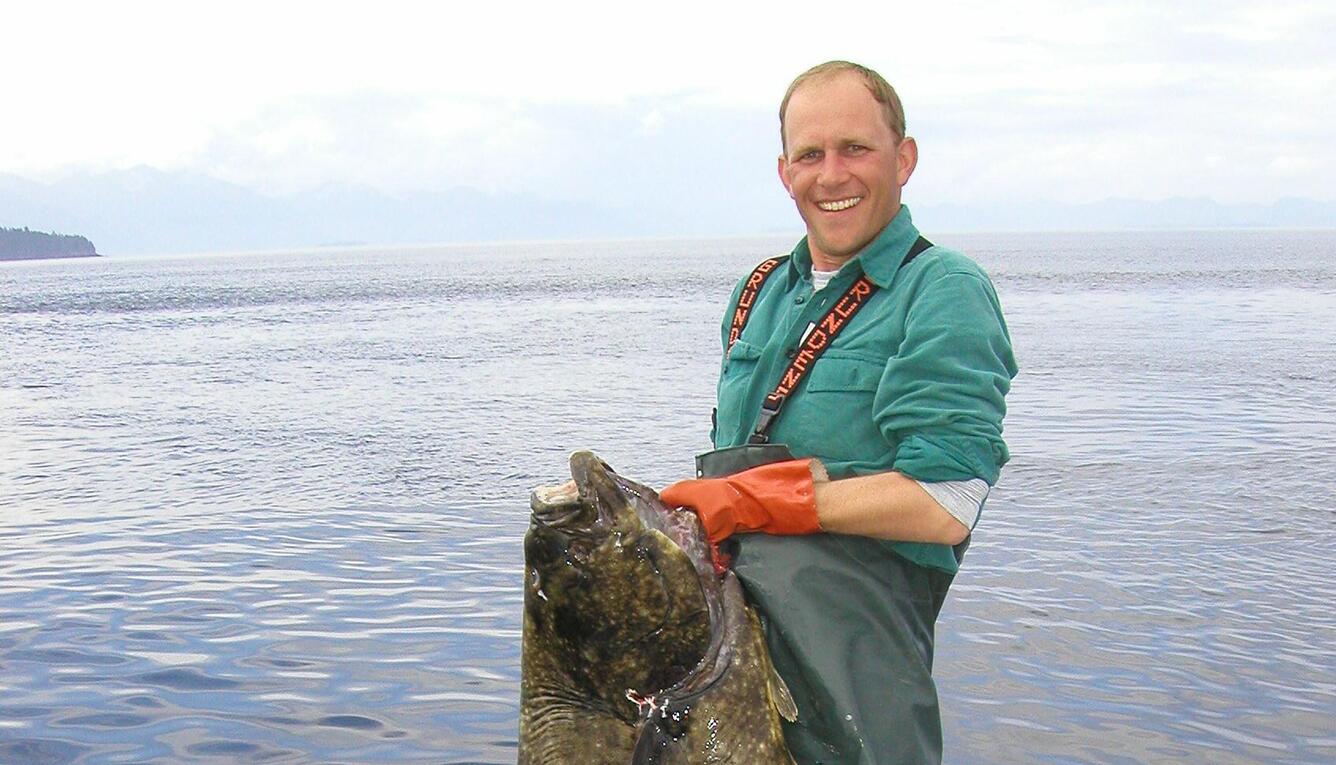 Chris Zimmerman holding a halibut he caught