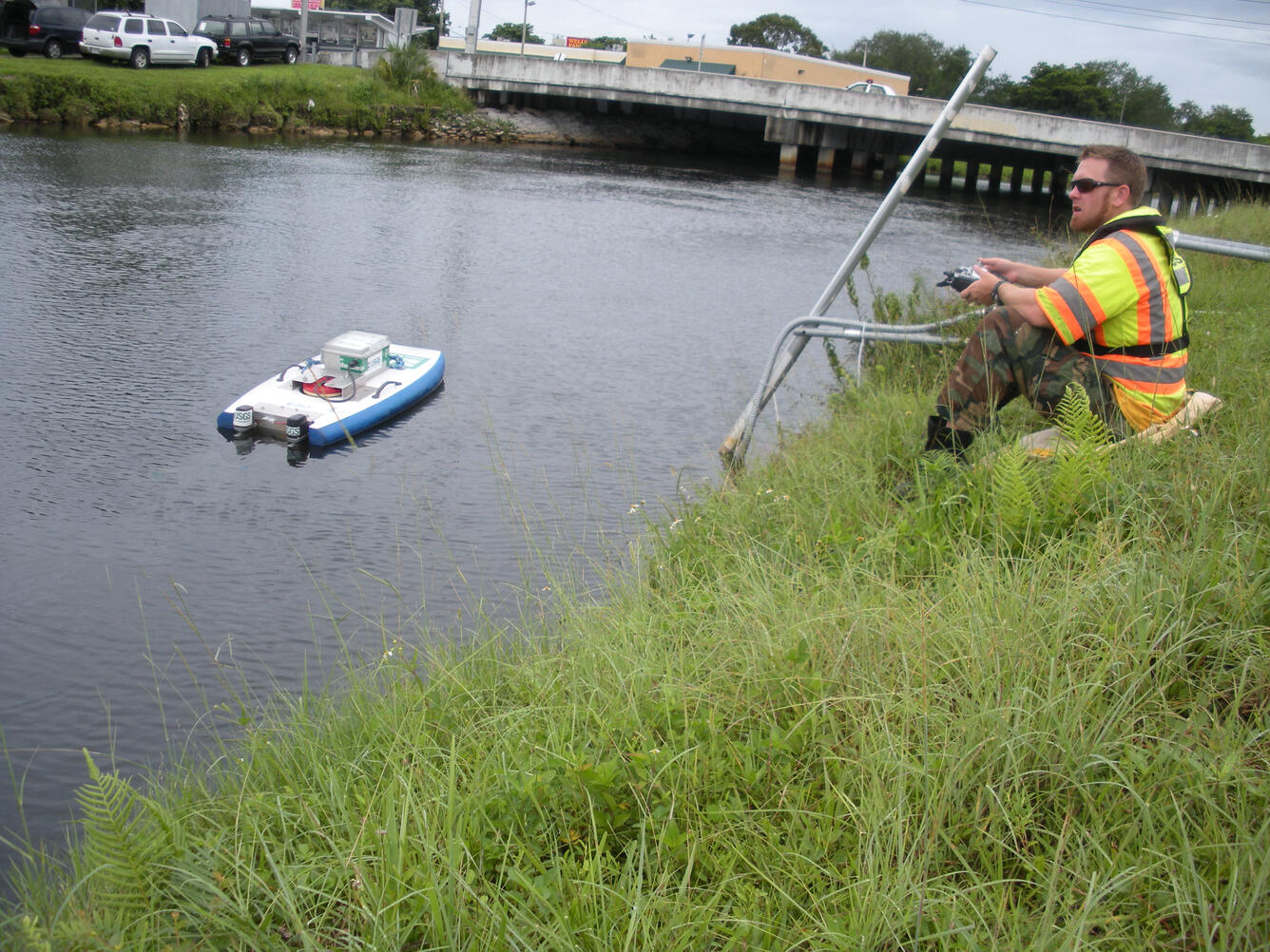 Florida Technician taking measurement with a ADCP by control remote.