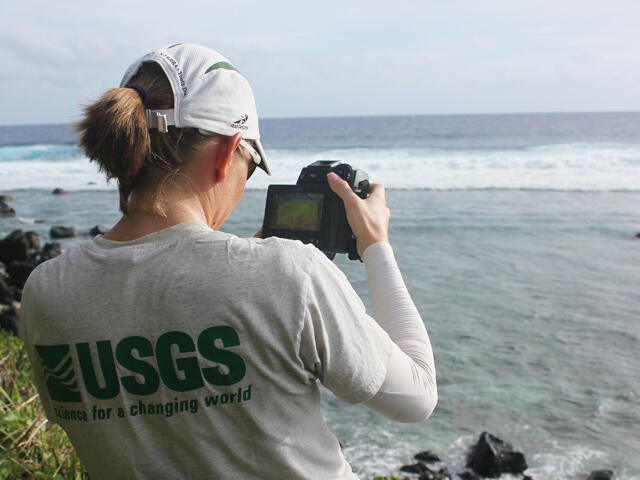 USGS scientist collects thermal images with camera next to a lagoon in US Samoa      