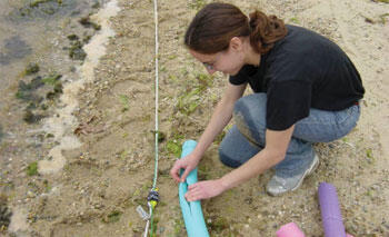 Hanan Karam (MIT) attaches floats to the cable and rope to help with the deployment.