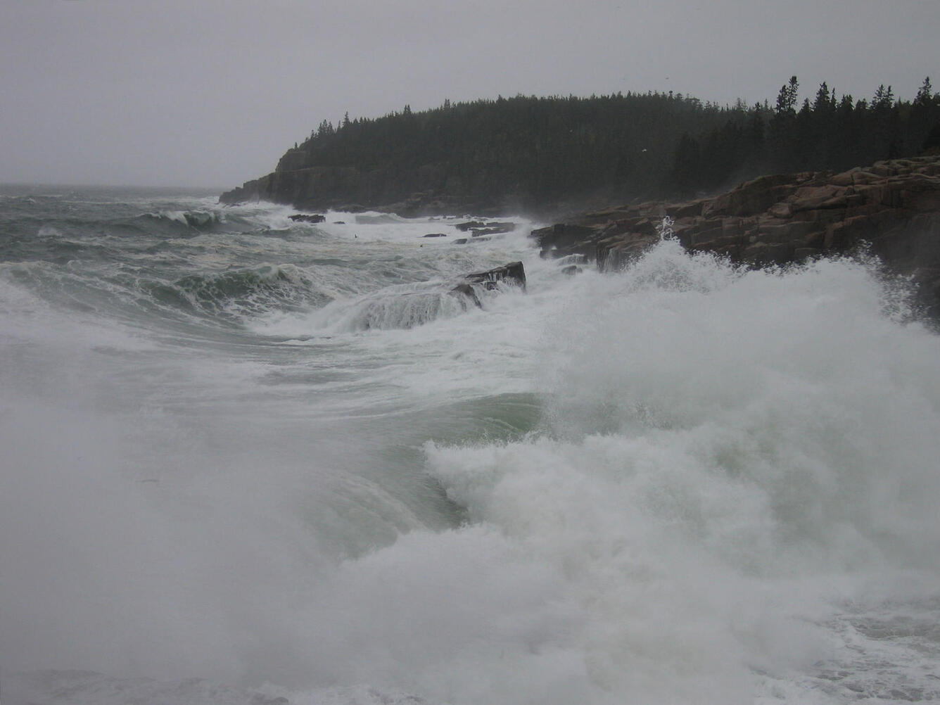 Rough seas batter the coastline during a storm.