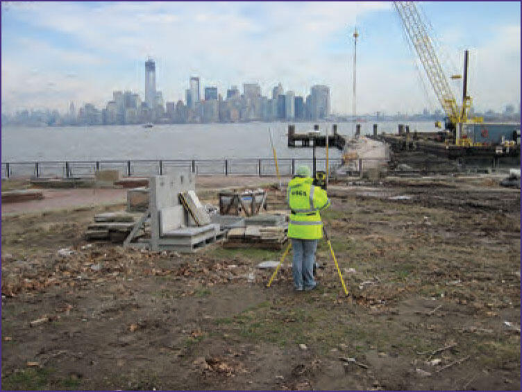 Photograph of USGS employee surveying a high-water mark on Liberty Island, New York, after Hurricane Sandy in 2012.