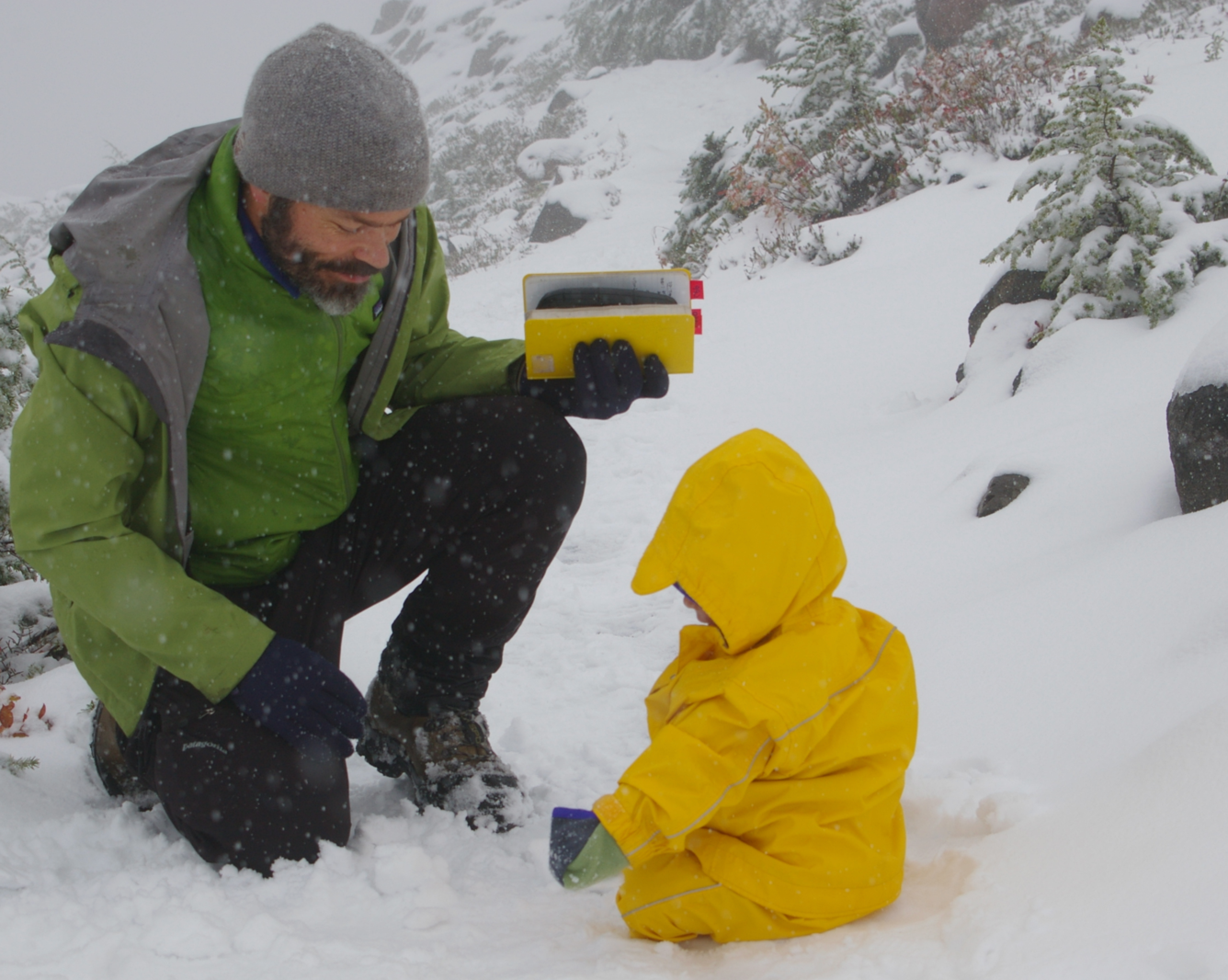 Research Ecologist Jeremy Littell and field assistant locate a snow sensor