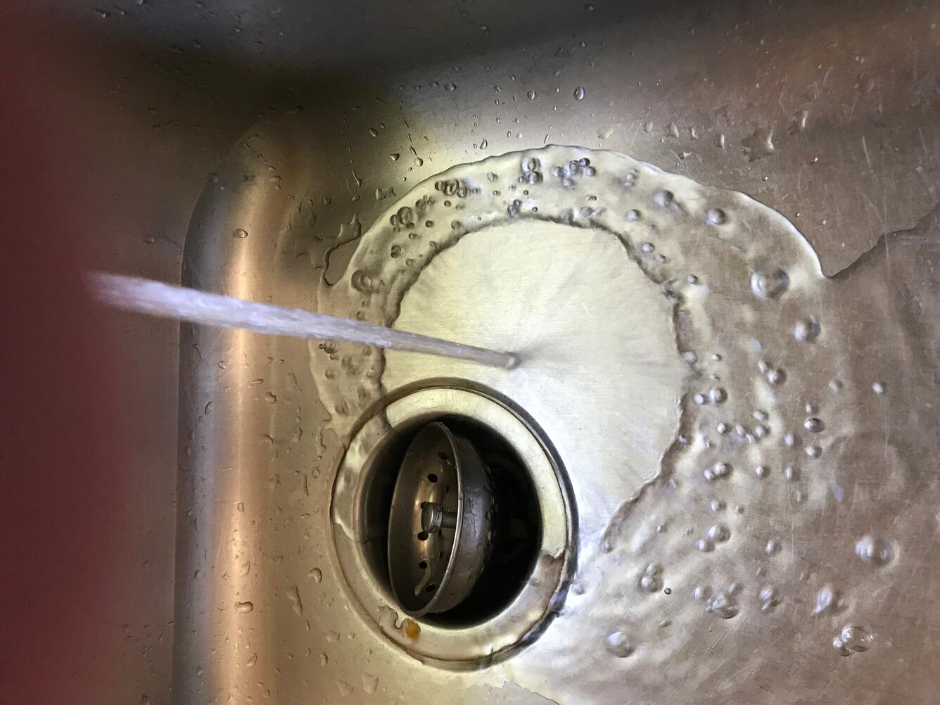 water flowing into kitchen sink