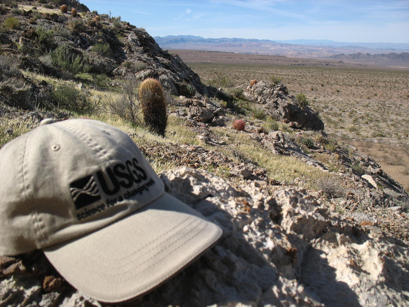USGS WERC hat in desert landscape