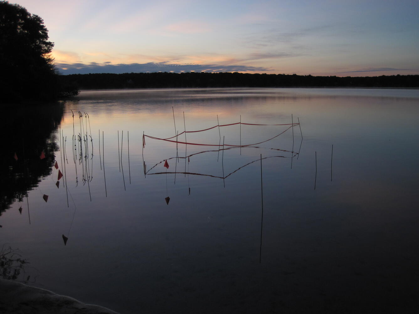 view across Ashumet Pond, Cape Cod, Massachusetts, with sampling grid markers in forground