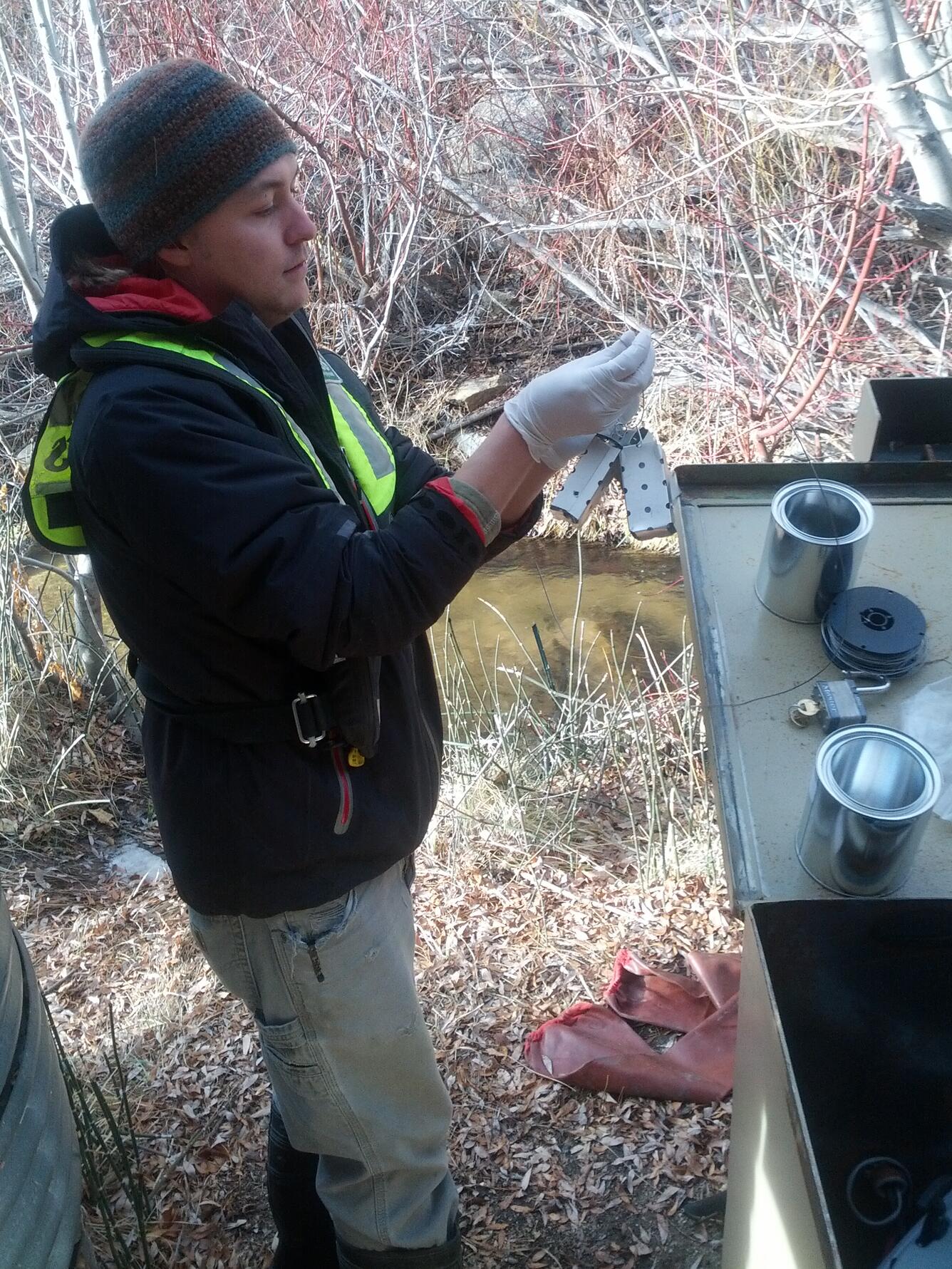 Scientist collects samples from an auto-sampler installed at the gaging station on Clear Creek in Nevada.