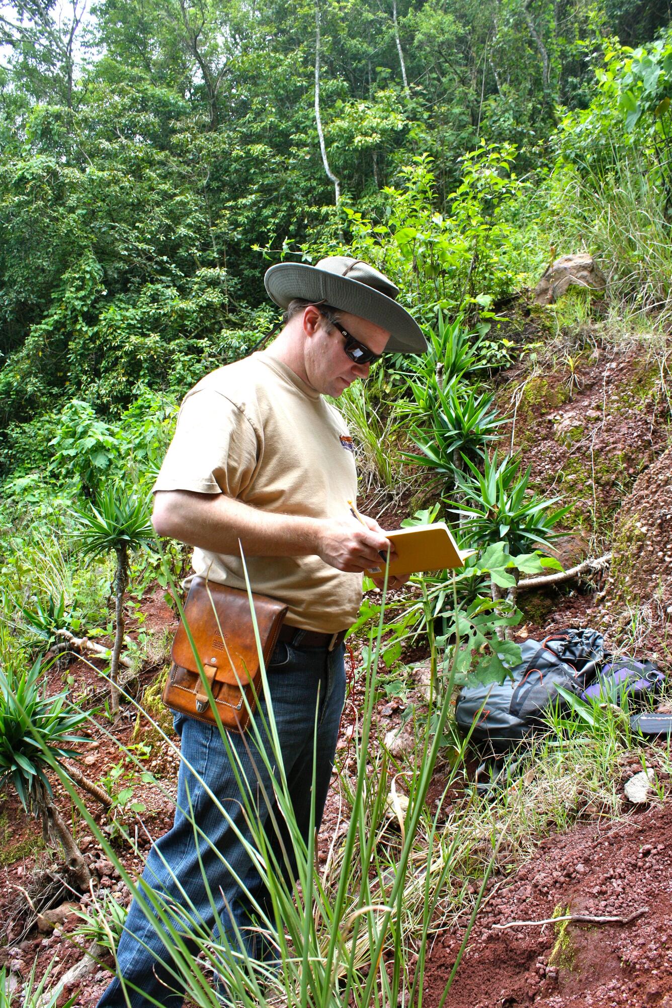 Photo of landslide scientist, Jonathan Godt, examining a soil profile