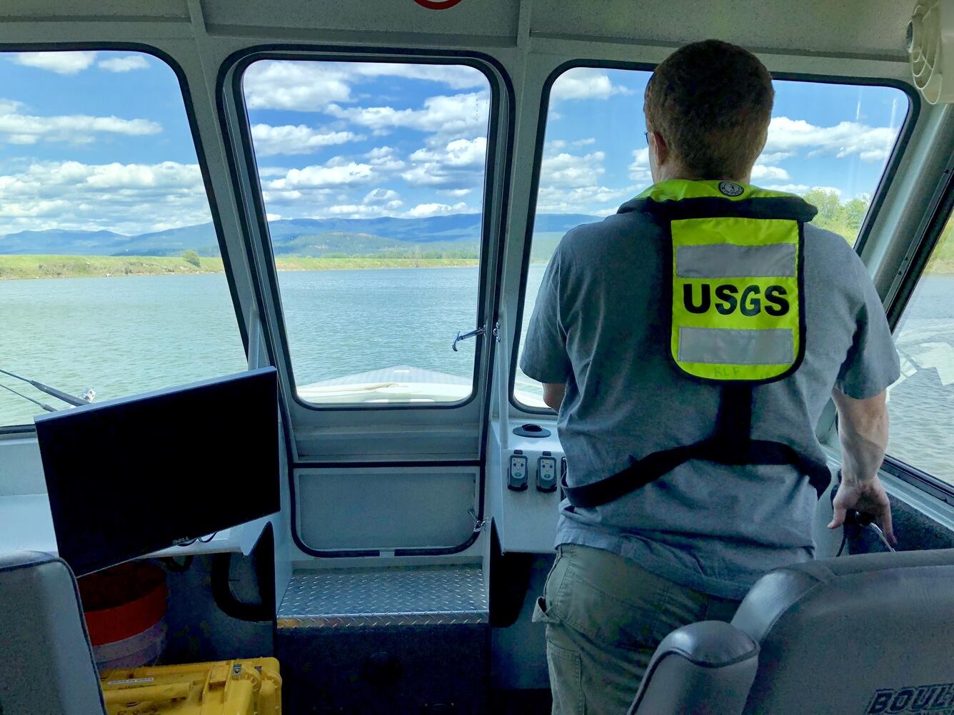 USGS hydrologist piloting research vessel on the Kootenai River, Idaho