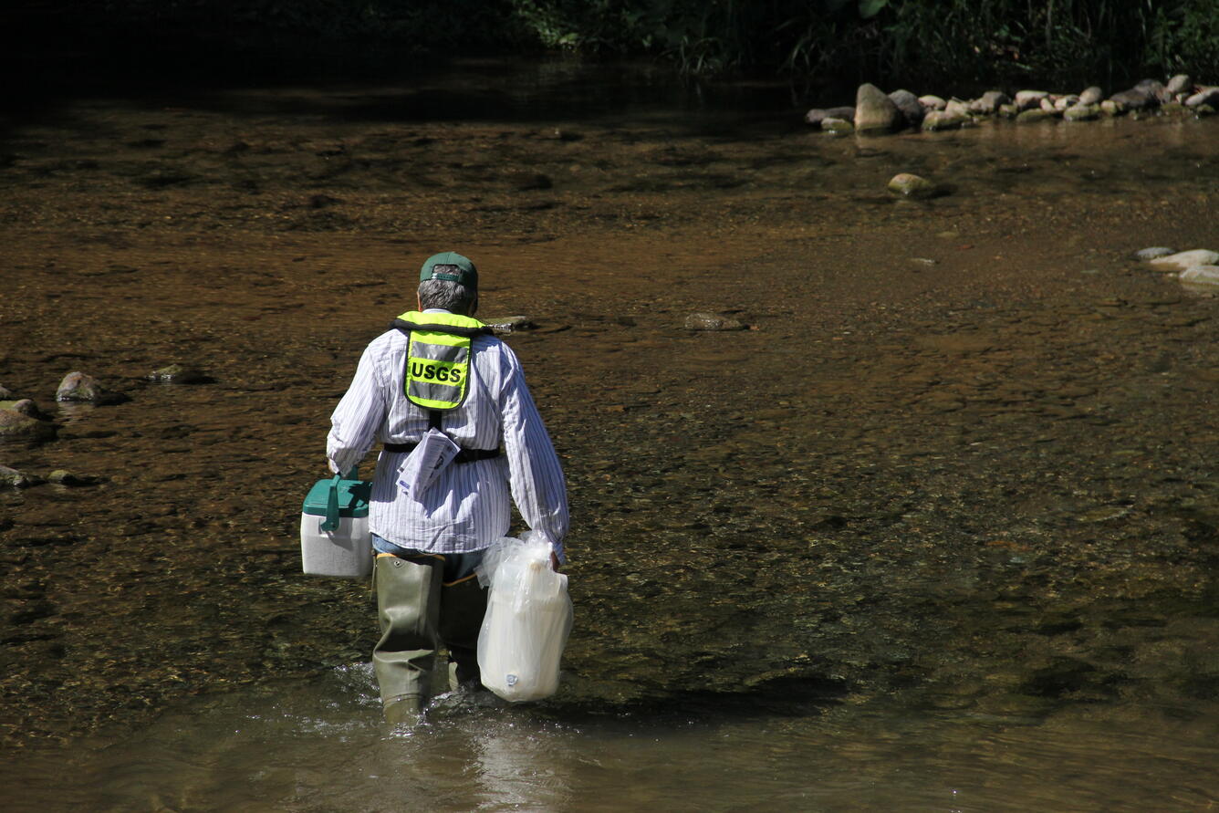 Technician carrying water quality.samples.
