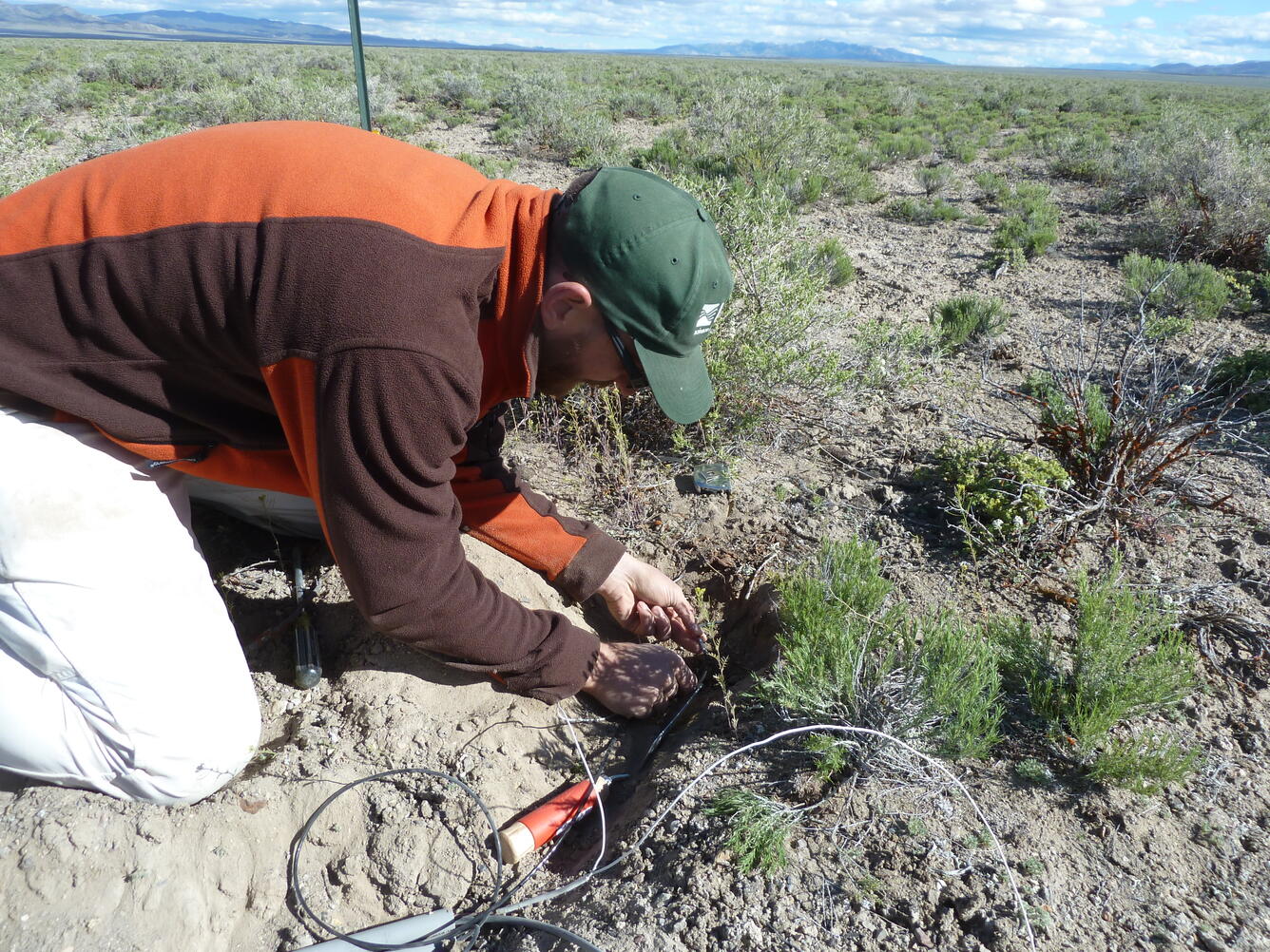 scientist placing wires for ET Site installation in Kobeh Valley