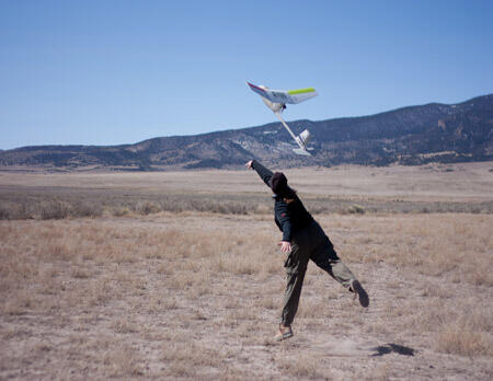 Scientist Leanne Hanson releasing an unmanned aircraft for a study. USGS photo. 