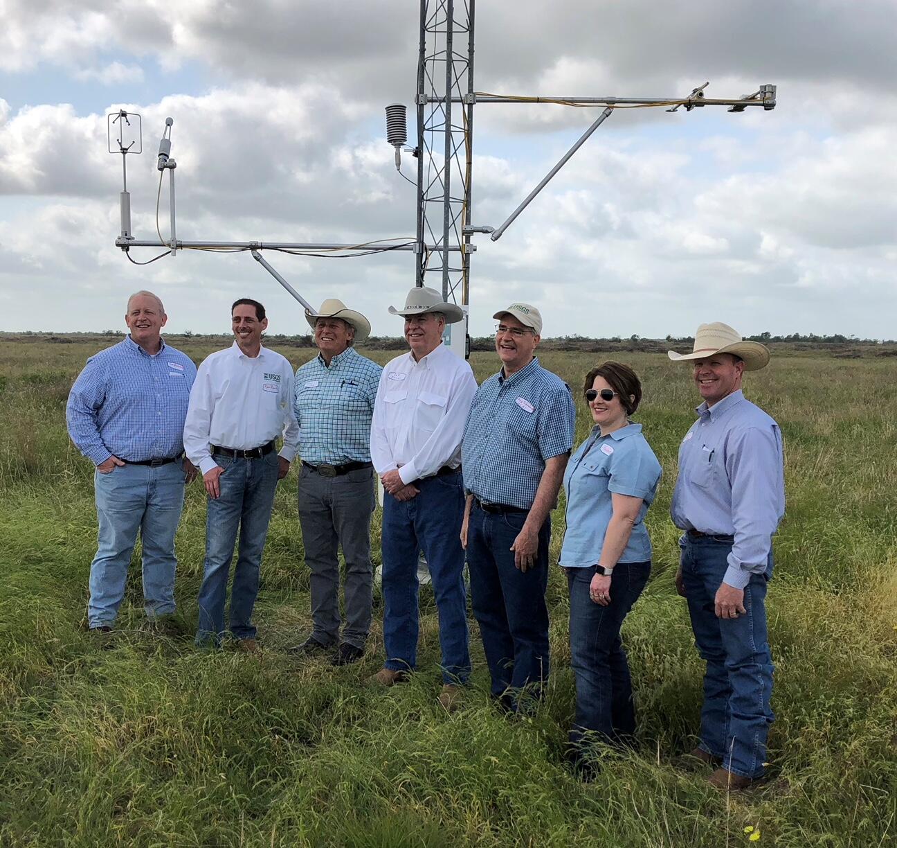 Cooperators and USGS Texas Water Science Center staff meeting at an evapotranspiration station