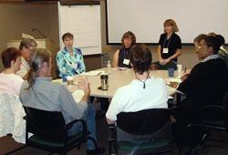 Working Group participants sitting around a table going through a group exercise.