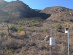 Telemetered rain gauge in Springs fire burn area with mountains in the background