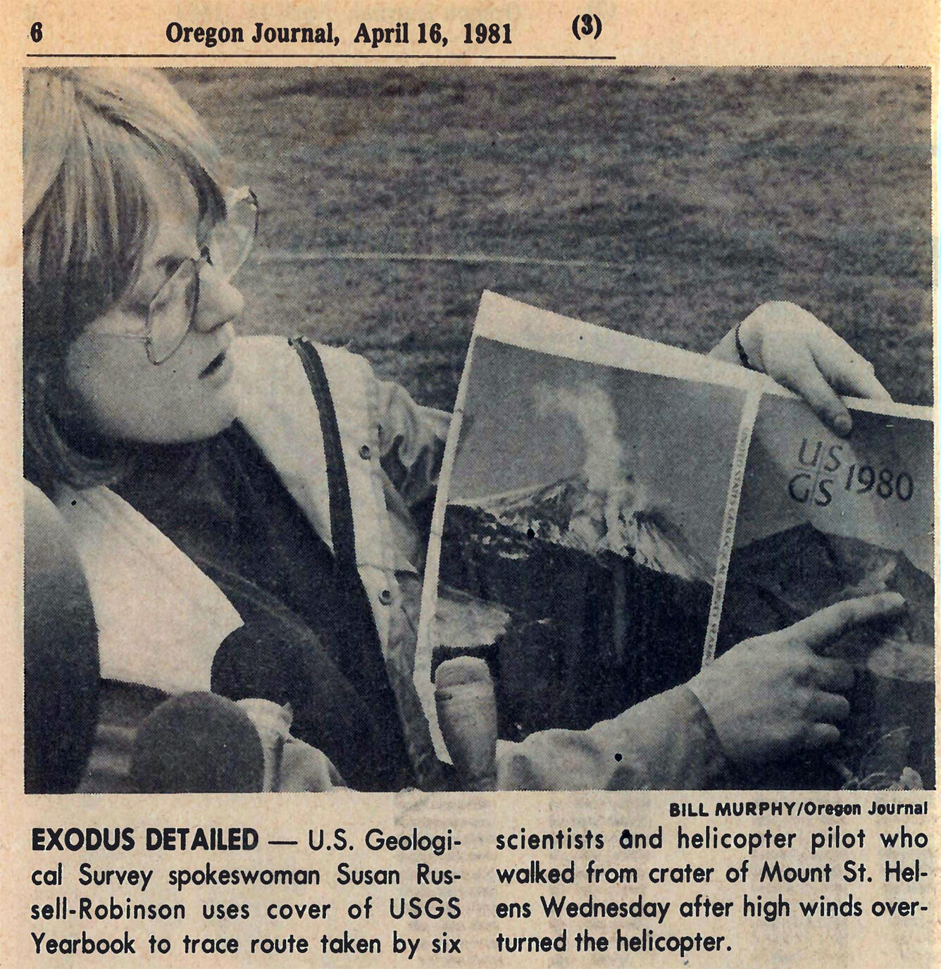 Newspaper clipping showing a photo of a woman pointing at a photo to explain it.