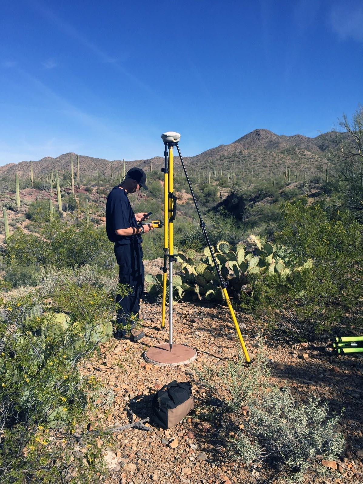 Person using equipment to collect Global Navigation Satellite System (GNSS) data.