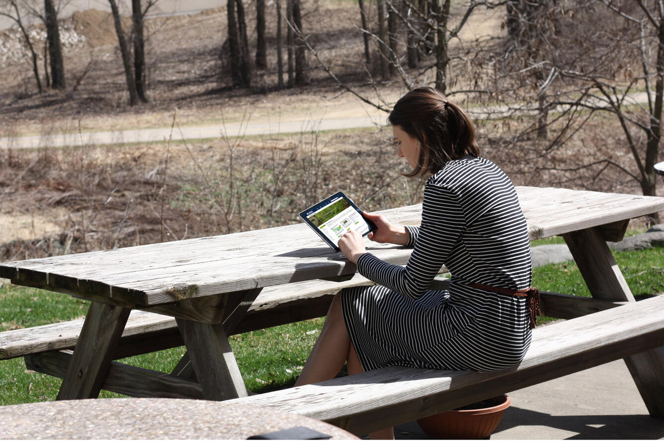 Woman looking at the new USGS Water Resources Mission Area website on a tablet