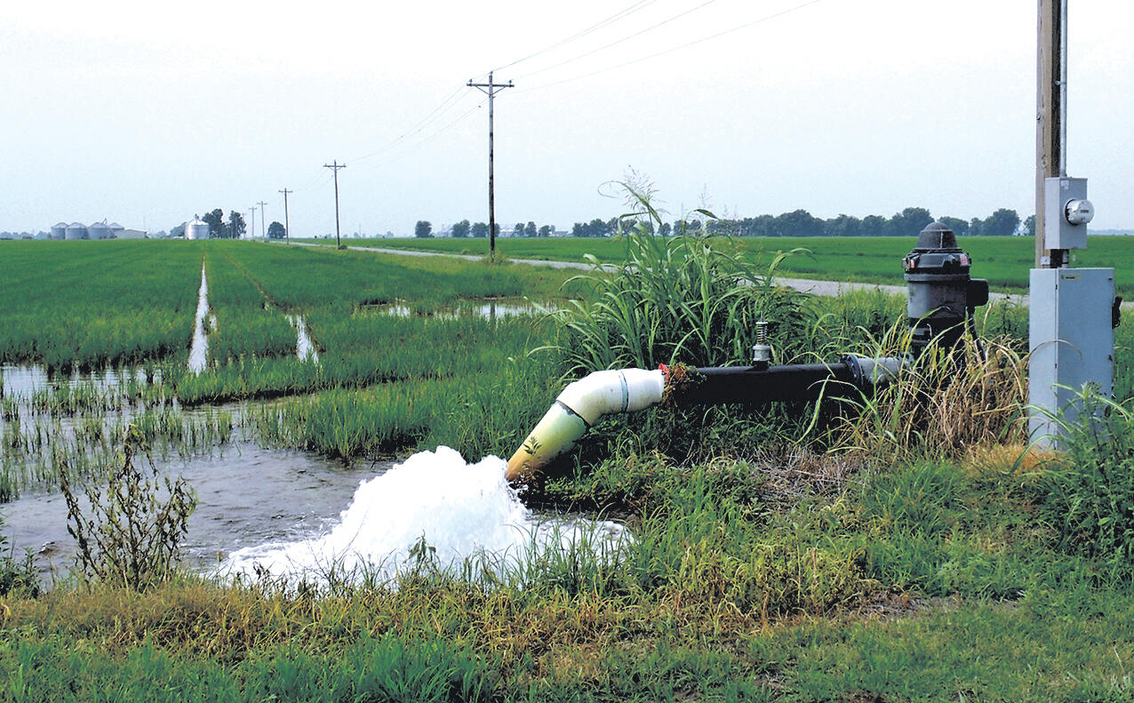 Photo of an irrigation well pouring water onto an agricultural field