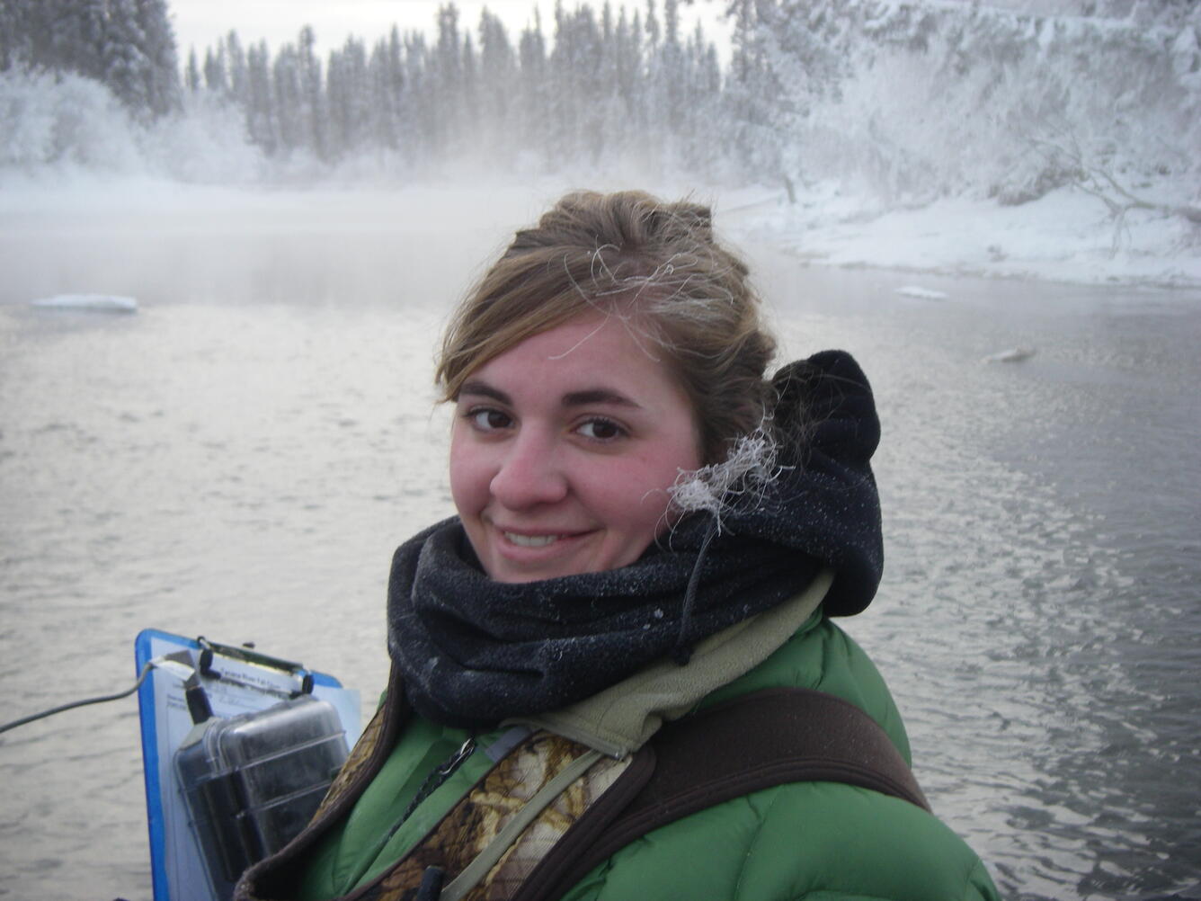 Vanessa von Biela with many layers of clothing and floatation on the Tanana River in the winter