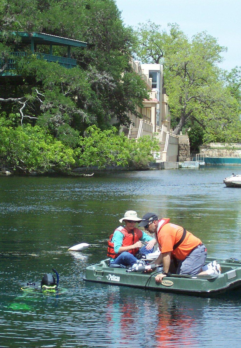 USGS personnel and a diver from Texas State University install a water-quality monitor at Diversion Spring.