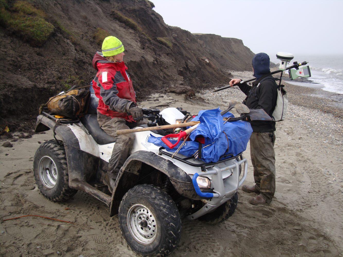 U.S. Geological Survey scientists collecting beach elevation data on an ATV in Alaska