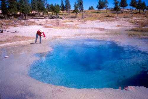 Scientist sampling water at Azure Hot Spring, Yellowstone National Park
