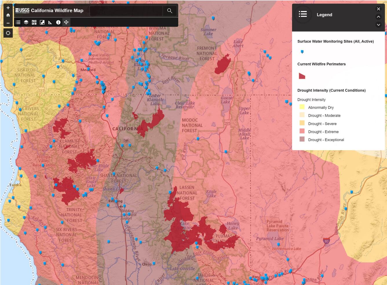 screenshot of mapping application showing drought intensity shaded in red to yellow, wildfire perimeters in brick red