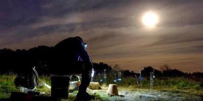 Research Scientist and project collaborator Jack McFarland samples a soil gas well under a full moon during a field carbon label