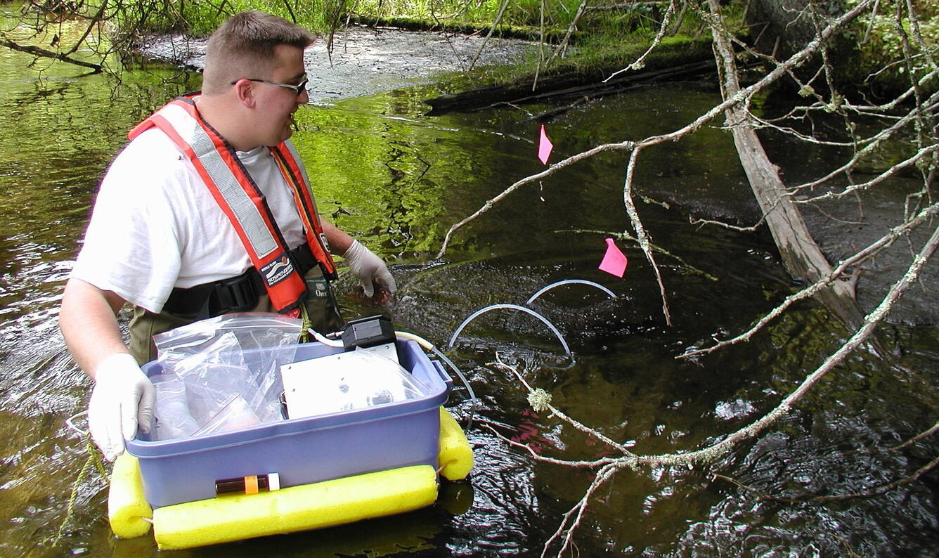 USGS scientist collecting samples of aquatic species from the Pike River, Wis., for later analysis of mercury contamination. 
