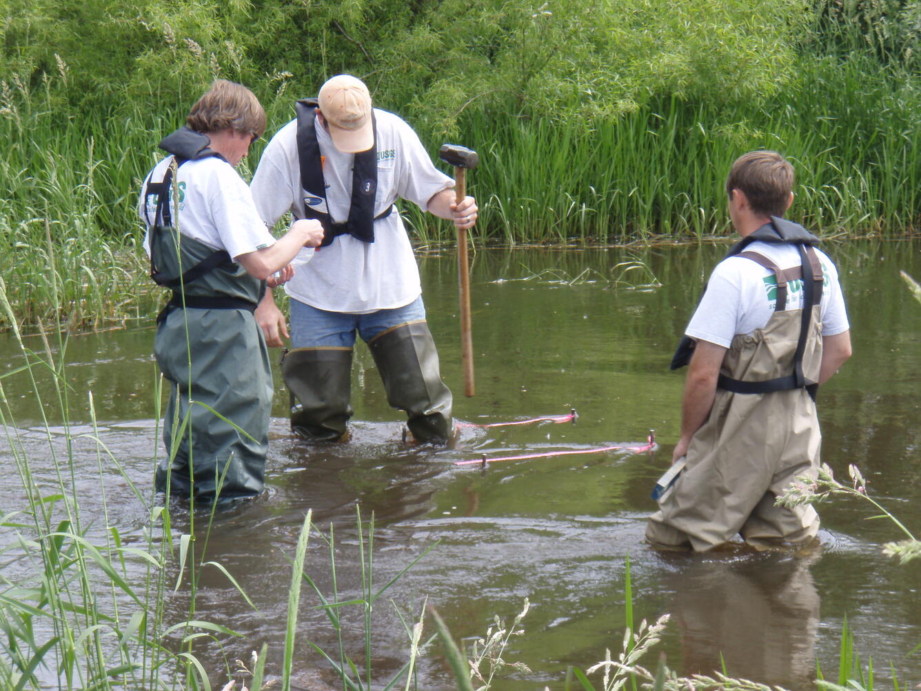 USGS scientists installing passive sediment samplers in an irrigation ditch near Hancock, Wisconsin