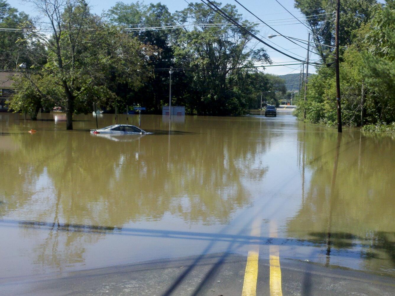 Car submerged in floodwaters