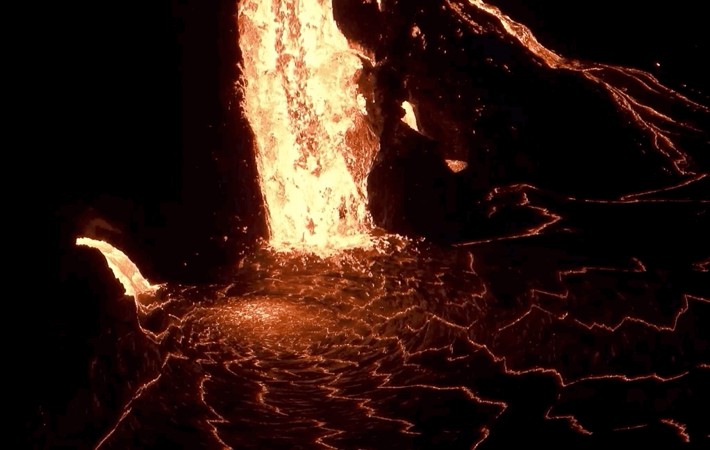 Lava flowing into a lava lake at night time. Bright colors