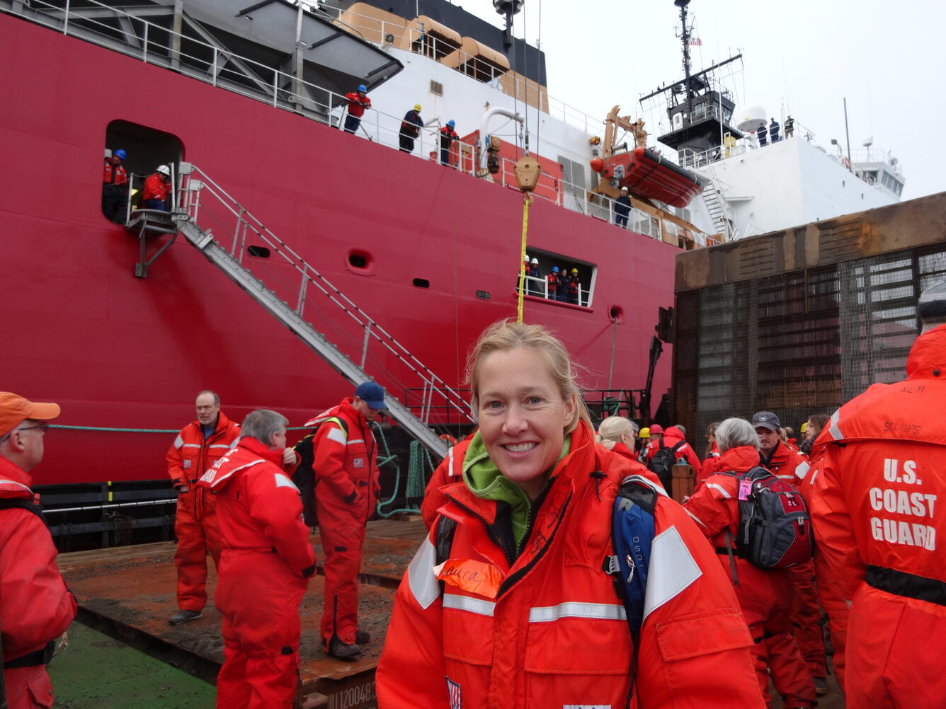 Laura Gemery stands on a dock in preparation to board a ship heading to the Arctic. 