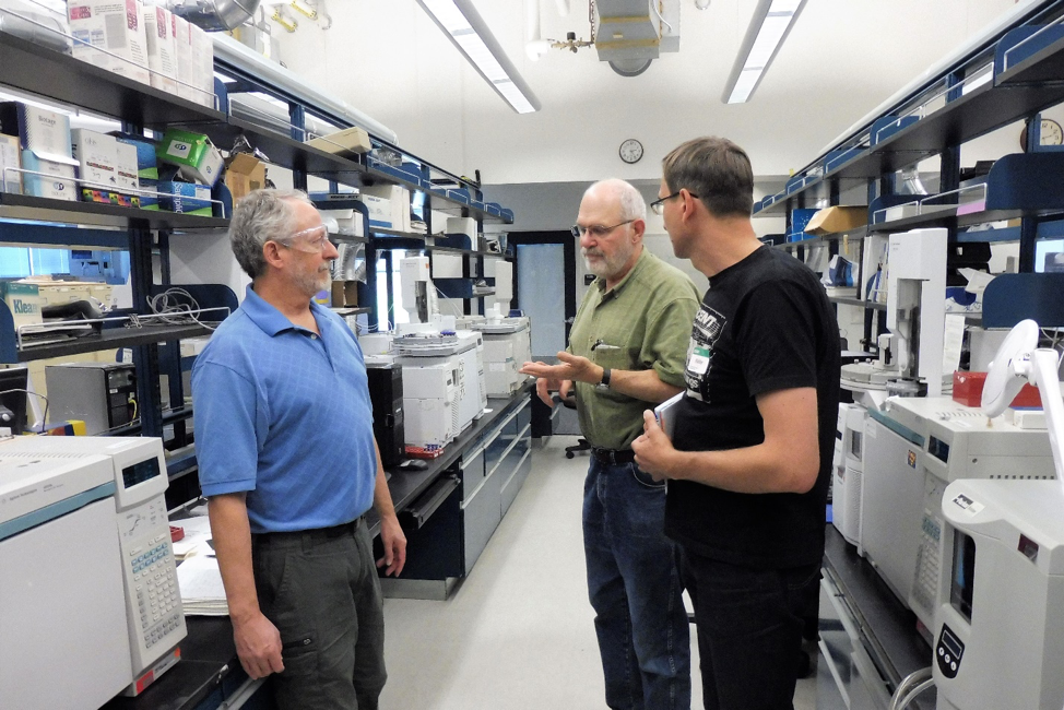 Three scientists touring a usgs lab