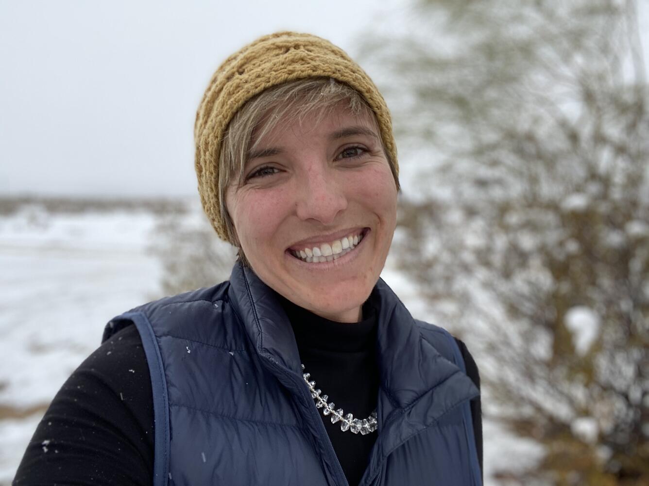 headshot of Whitney Seymour with a snowy desert background