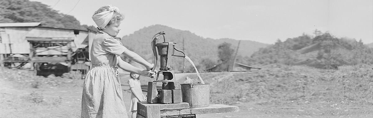 Daughter of a miner getting water at the well