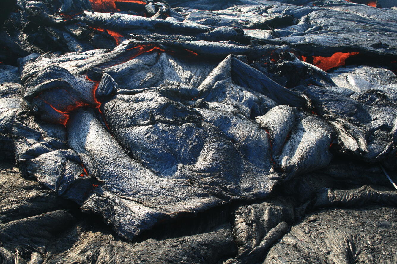 Sluggish pāhoehoe briefly surges over the levees of the well-establ...